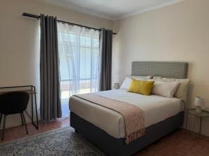 Ένα ή περισσότερα κρεβάτια σε δωμάτιο στο Maqoco Guesthouse