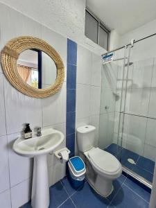 a bathroom with a sink and a toilet and a mirror at Hostel Beach House in Rincón +88 photos