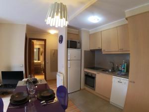 a kitchen with a table and a dining room at Soldeu Paradis La Solana in El Tarter