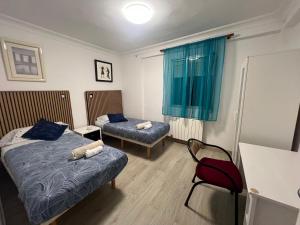 En eller flere senge i et værelse på ZARAGOZA CENTRAL APARTMENT