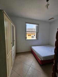 En eller flere senge i et værelse på Edifício Açucena Beira Mar - Praia do Tombo