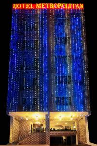 a building is lit up with blue lights at Hotel Metropolitan in Jaipur