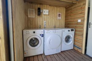 two washing machines and a washer and dryer in a room at L'Escapade Créole in Saint-François