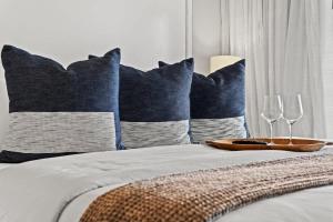 a bed with two wine glasses and a tray on it at Inn at Seacrest Beach 409 in Inlet Beach