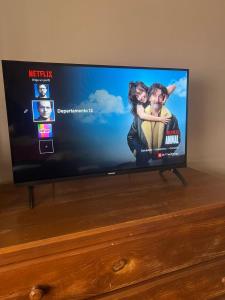 a flat screen tv sitting on top of a dresser at Departamento a media cuadra del mar Edificio"Mont Blanc" in Villa Gesell