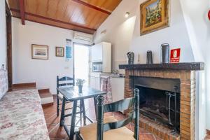 a living room with a fireplace and a table at Cubo's Casa Rural Cortijo del Puntal in Teba