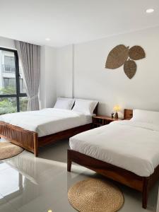 a bedroom with two beds and a window at 22 Homestay-near AEON Mall 3 & Techo International Aiport in Ta Khmau