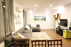 a living room with a couch and a tv at Suite Golan in Neot Golan