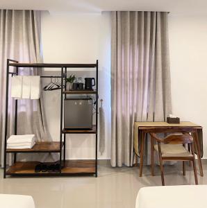 a living room with a tv and a table at 22 Homestay-near AEON Mall 3 & Techo International Aiport in Ta Khmau