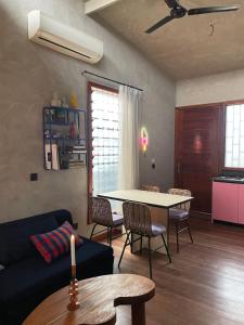a living room with a couch and a table at The Urban Farm House in Accra +3 photos