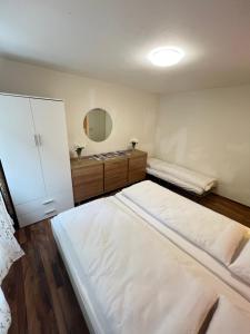 a room with two beds and a mirror at Perle Apartment in Interlaken