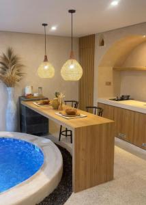 a kitchen and living room with a hot tub at Andara Villa Yogyakarta in Yogyakarta