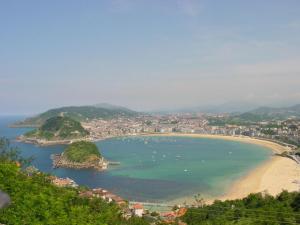 a view of a beach with boats in the water at La Galería in Donostia-San Sebastián