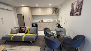 a living room with a couch and a glass table at Stylish Cashel Townhouse Stay in Linwood +18 photos