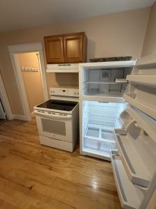 a kitchen with an open refrigerator with its door open at The Coastal Connection in South Portland +5 photos