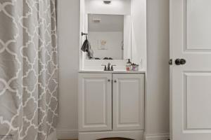 a white bathroom with a sink and a mirror at Corporate Cottage on Circle in Thornville +11 photos