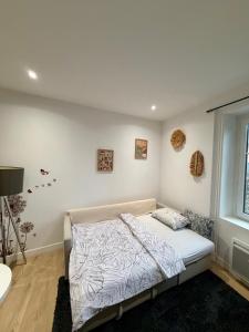 a bedroom with a bed and a window at Harmony in Limonest