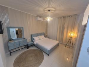 a bedroom with a bed and a dresser and a mirror at פינוק של סוויטה in Manot