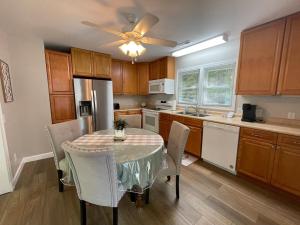 a kitchen with a table with chairs and a ceiling fan at Deer Run Creek Cottage in Mountain City