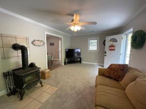 a living room with a couch and a wood stove at Deer Run Creek Cottage in Mountain City