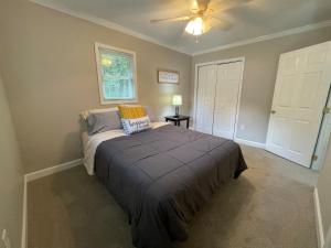 a bedroom with a bed and a ceiling fan at Deer Run Creek Cottage in Mountain City
