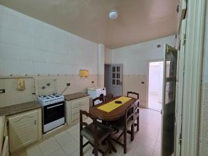 a kitchen with a table and a stove top oven at apartment S3 ground floor in Mahdia +6 photos