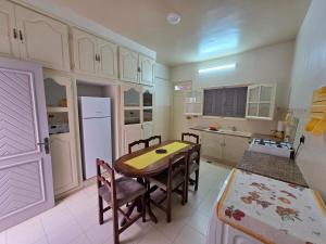 a kitchen with a table and chairs in a room at apartment S3 ground floor in Mahdia