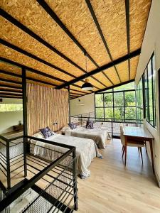 a large room with two beds and a table at Chalets HUITACA in Choachí