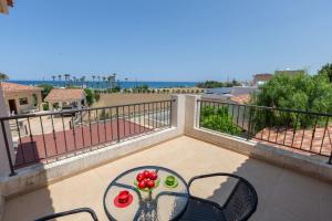 a table and chairs on a balcony with a view at Seaview Villa Mia in Lachi