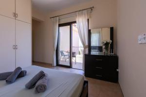 a bedroom with a bed and a view of a balcony at Seaview Villa Mia in Lachi +31 photos