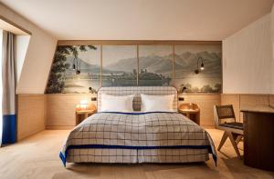 a bedroom with a bed and a painting on the wall at Sorell Boutique-Hotel Speer Rapperswil in Rapperswil-Jona