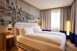 a bedroom with a large white bed in a room at Sorell Boutique-Hotel Speer Rapperswil in Rapperswil-Jona