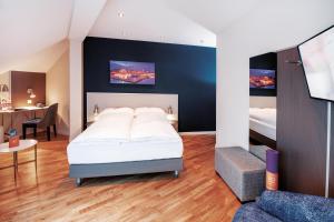 a bedroom with a bed and a living room at Sorell Hotel Rex Zürich in Zürich +15 photos
