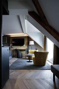 a living room with a couch and a table at Sorell Boutique-Hotel Seefeld Zürich in Zürich