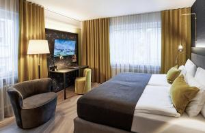 a hotel room with a bed and a chair at Sorell Boutique-Hotel Seefeld Zürich in Zürich +54 photos