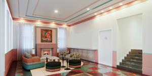 a lobby with a fireplace and a couch and chairs at Waldorf Towers South Beach in Miami Beach