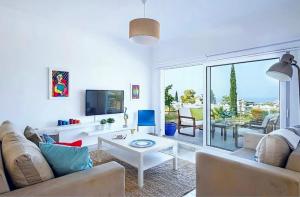 a living room with a couch and a table at Amazing Sea View -3 Bed Ground Floor Garden Apartment in Kérynia +34 photos