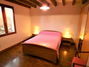a bedroom with a bed and two lights on two tables at Notre bergerie in Soustons