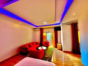 a living room with a red couch and blue lights at AS Appartement meublé in Bamako