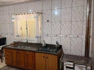 a kitchen with a sink and a stove in it at Omma's Haus - Casa de Vó perto de Gramado in Morro Reuter +39 photos