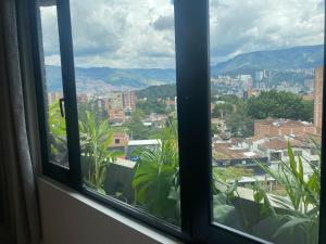 a window with a view of a city at Hotel Ryo 74b Piso 7 Vip in Medellín