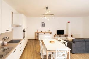 a kitchen and living room with a table and a couch at Dimore Rosselli Suites in Fasano