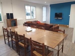 a living room with a wooden table and chairs at Logis Coeur de Bretagne in Bieuzy-les Eaux