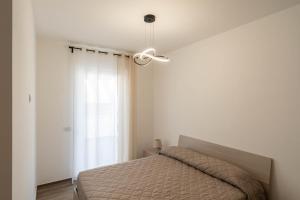 a bedroom with a bed and a ceiling fan at Dimore Rosselli Suites in Fasano