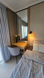 a bedroom with a bed and a desk and a mirror at Beachfront Premium Apartment with Sunset, Pools & Sea View in Portimão +25 photos