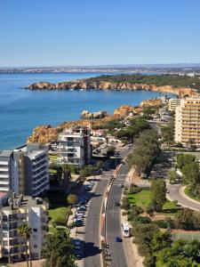an aerial view of a city and the ocean at Beachfront Premium Apartment with Sunset, Pools & Sea View in Portimão