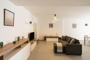 a living room with a couch and a tv at Dimore Rosselli Suites in Fasano
