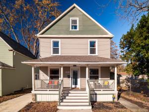 a white house with a porch and stairs at Cleveland Escape - Hot Tub - Karaoke Machine - Sleeps 12 in Cleveland