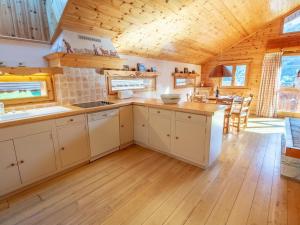 a kitchen with white cabinets and a wooden ceiling at Spacieux Duplex en Centre Station avec Balcon et Wi-Fi - FR-1-688-35 in Méribel