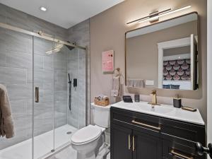 a bathroom with a toilet and a sink and a shower at Cleveland Escape - Hot Tub - Karaoke Machine - Sleeps 12 in Cleveland +167 photos